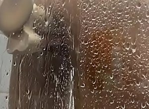 Brincando com pau de borracha debaixo do chuveiro