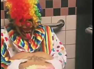 Girl rides clown in bathroom stall