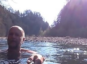naked uncut bear chilling in the river