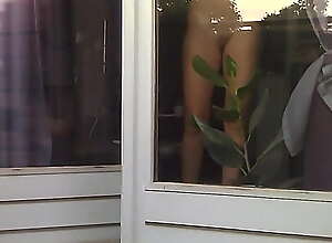 Naked girl caught fooling around by the window