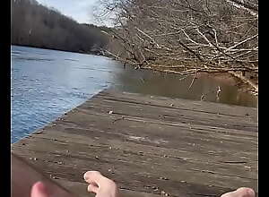Guy masturbates and cums butt naked on dock