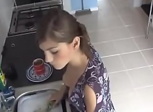 Beauty Exposed in down blouse while doing dishes